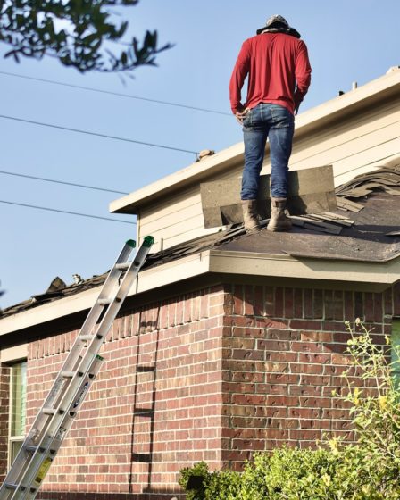 a man standing on the roof of a house