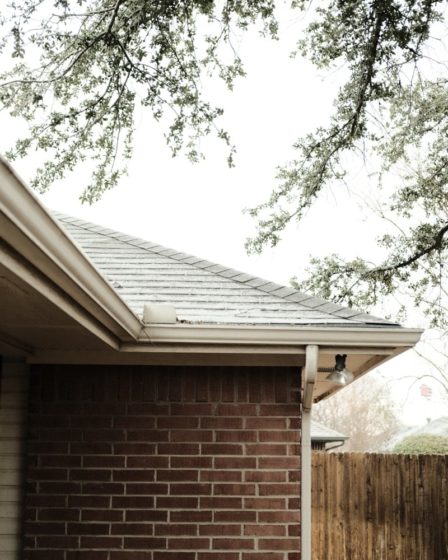 a brick house with a tree in front of it