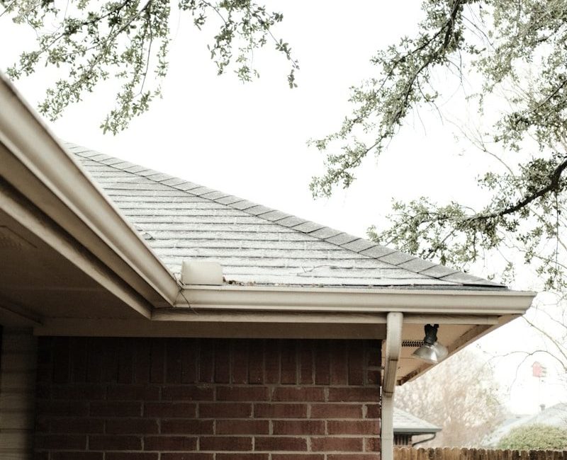 a brick house with a tree in front of it